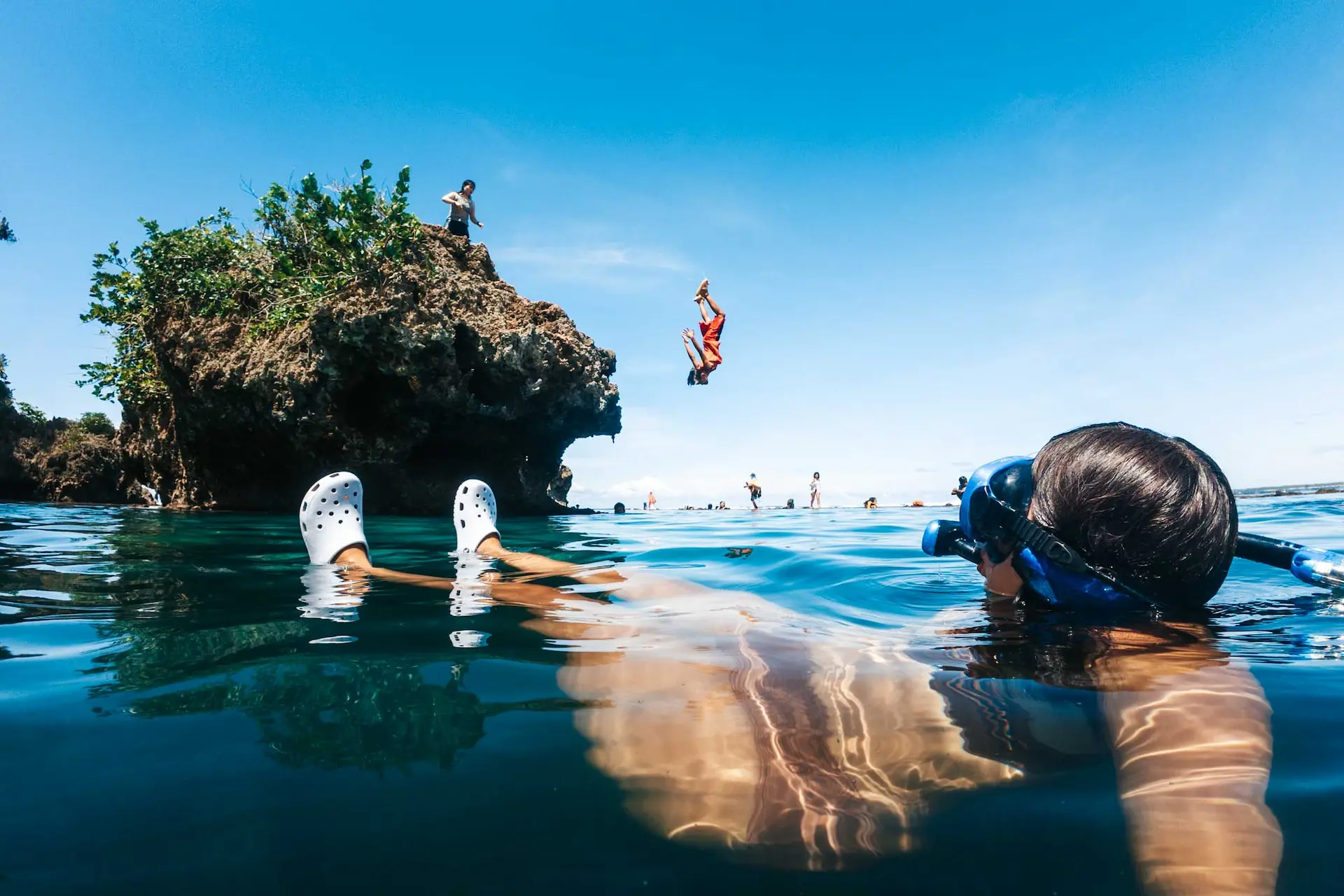 Cliff jumping and swimming in Magpupungko's crystal-clear tidal pools