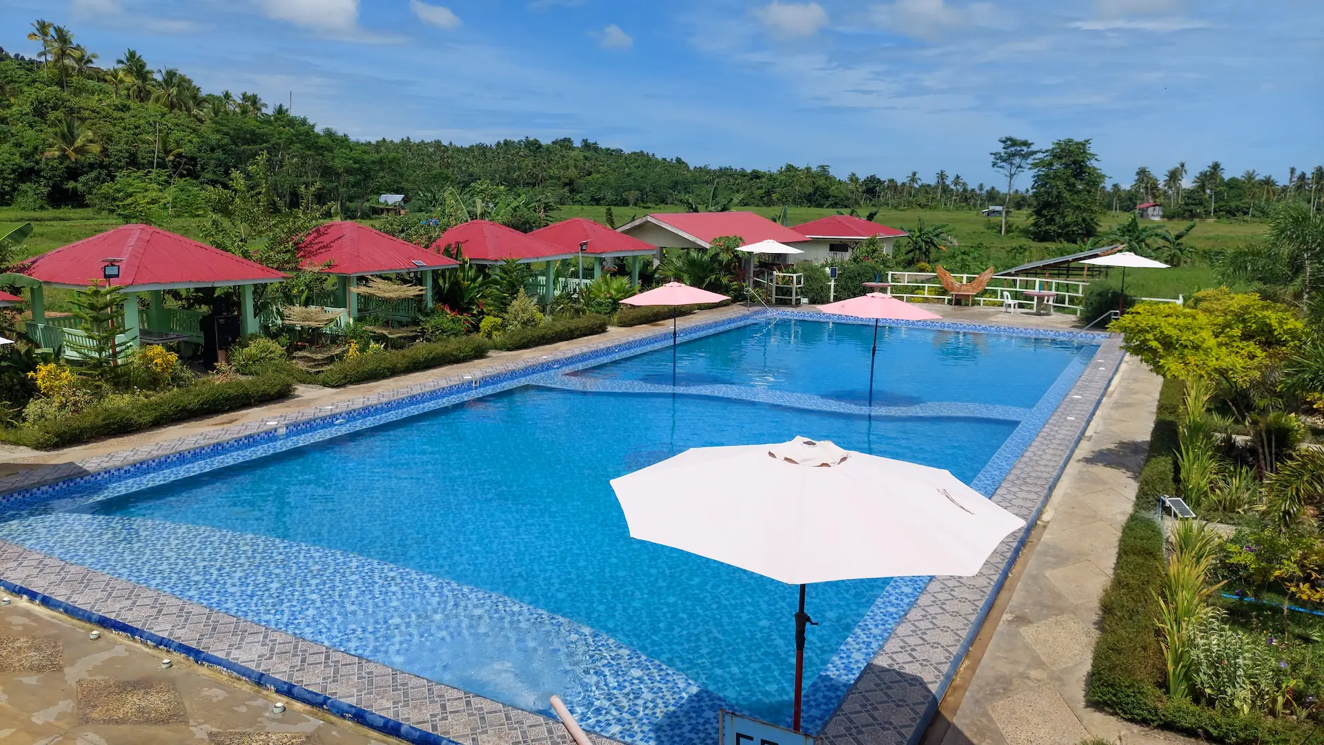 Guests enjoying authentic hospitality in Siargao at Mariden Resort poolside