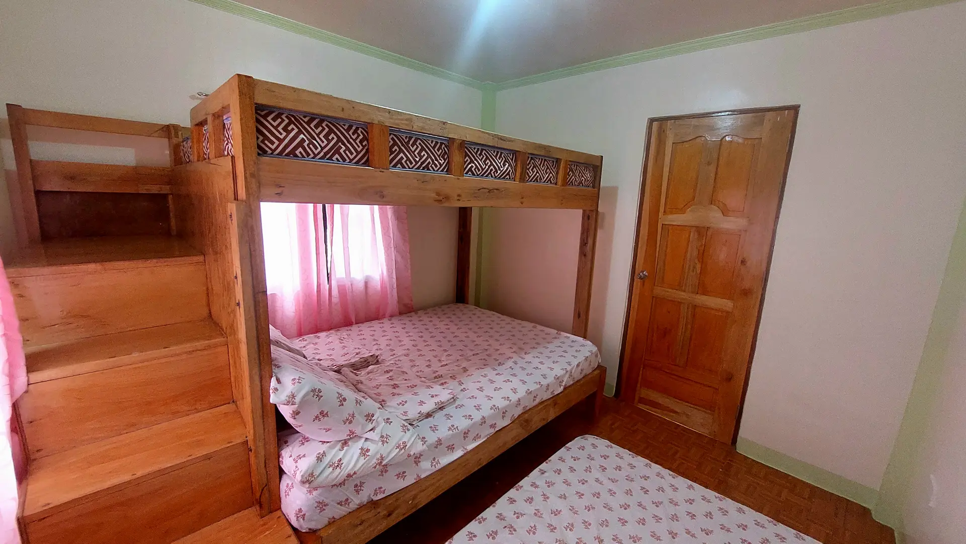 Snug Family Room interior with double bed, bunk bed, and living area - sleeps 6 guests (up to 8 with extra beds) at Mariden Resort Siargao Del Carmen